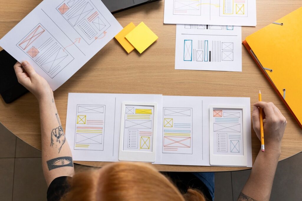 female web designer taking notes office
