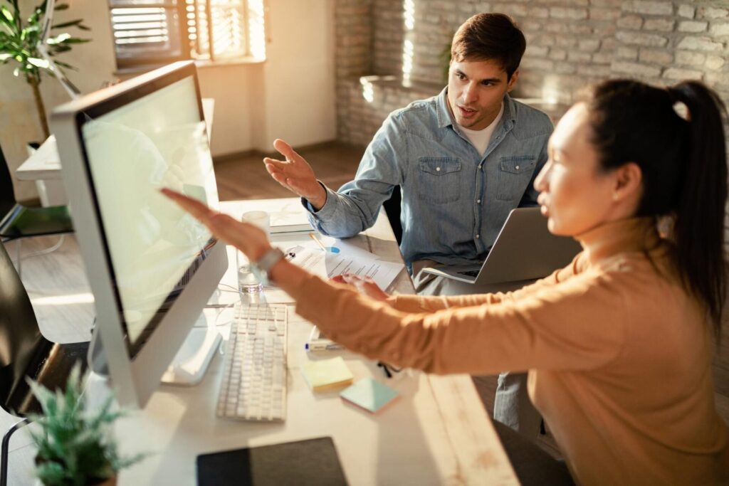 young businessman his colleague discussing while working desktop pc office